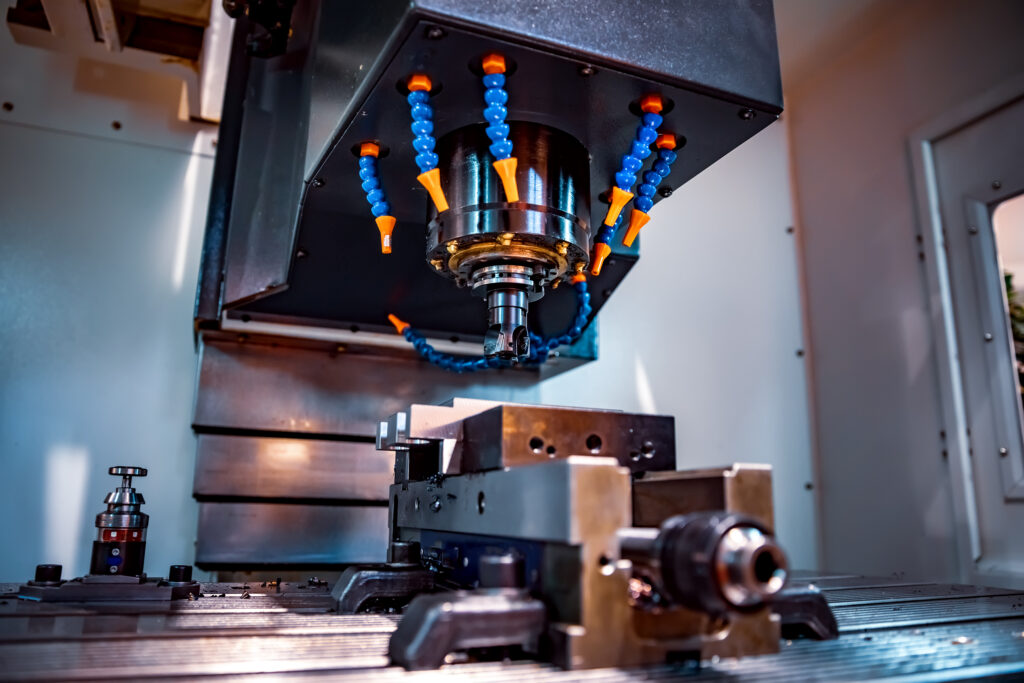 Metalworking CNC milling machine. Cutting metal modern processing technology. Small depth of field. Warning - authentic shooting in challenging conditions. A little bit grain and maybe blurred.
